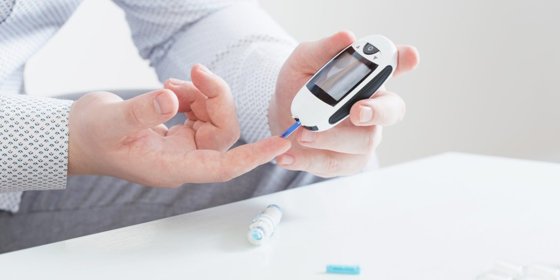 Man using glucose meter
