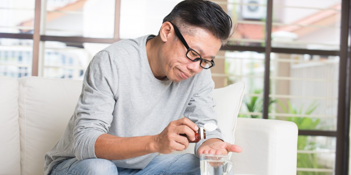 Middle-aged Man Taking Medicine