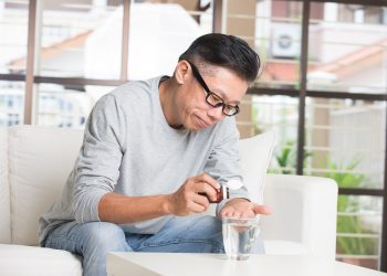 Middle-aged Man Taking Medicine