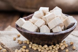 Tofu (detailed close-up shot) on wooden background